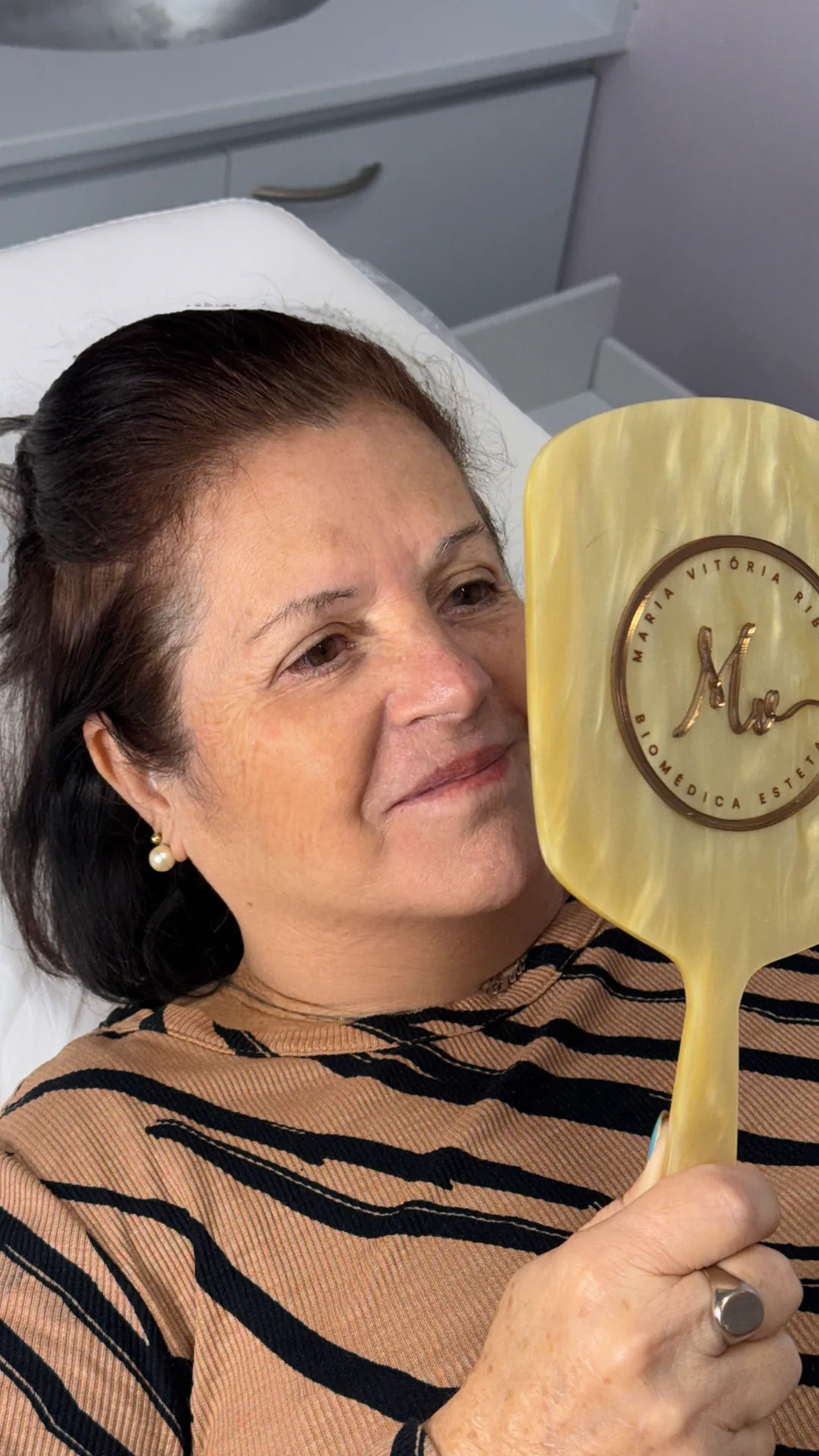 Cliente olhando o resultado num espelho dourado